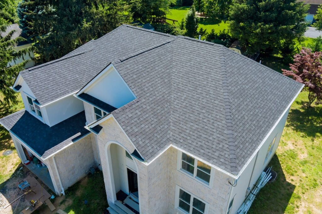 the top of a shingle roof on a beautiful white hoes