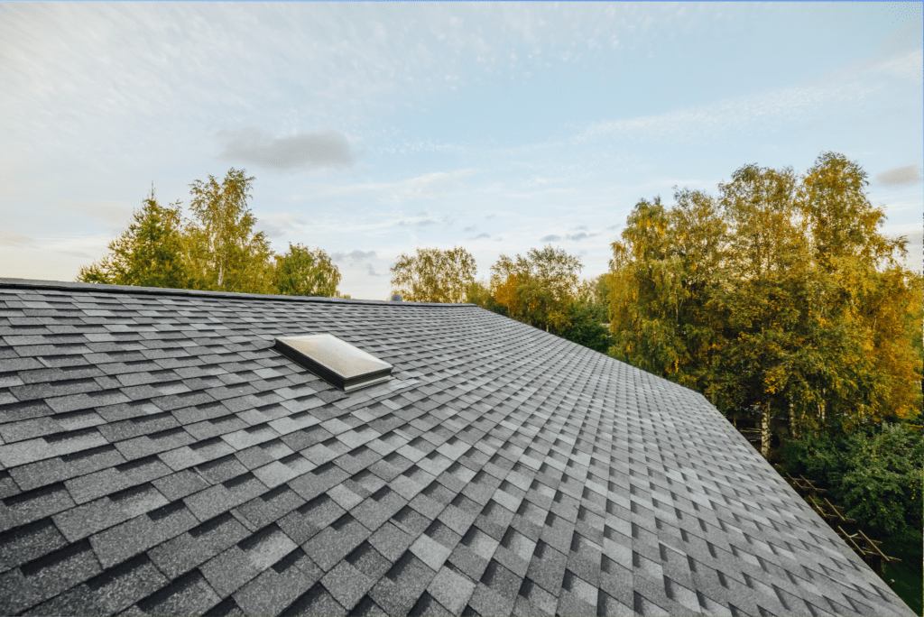 Asphalt tile roof with chimney on new home under construction